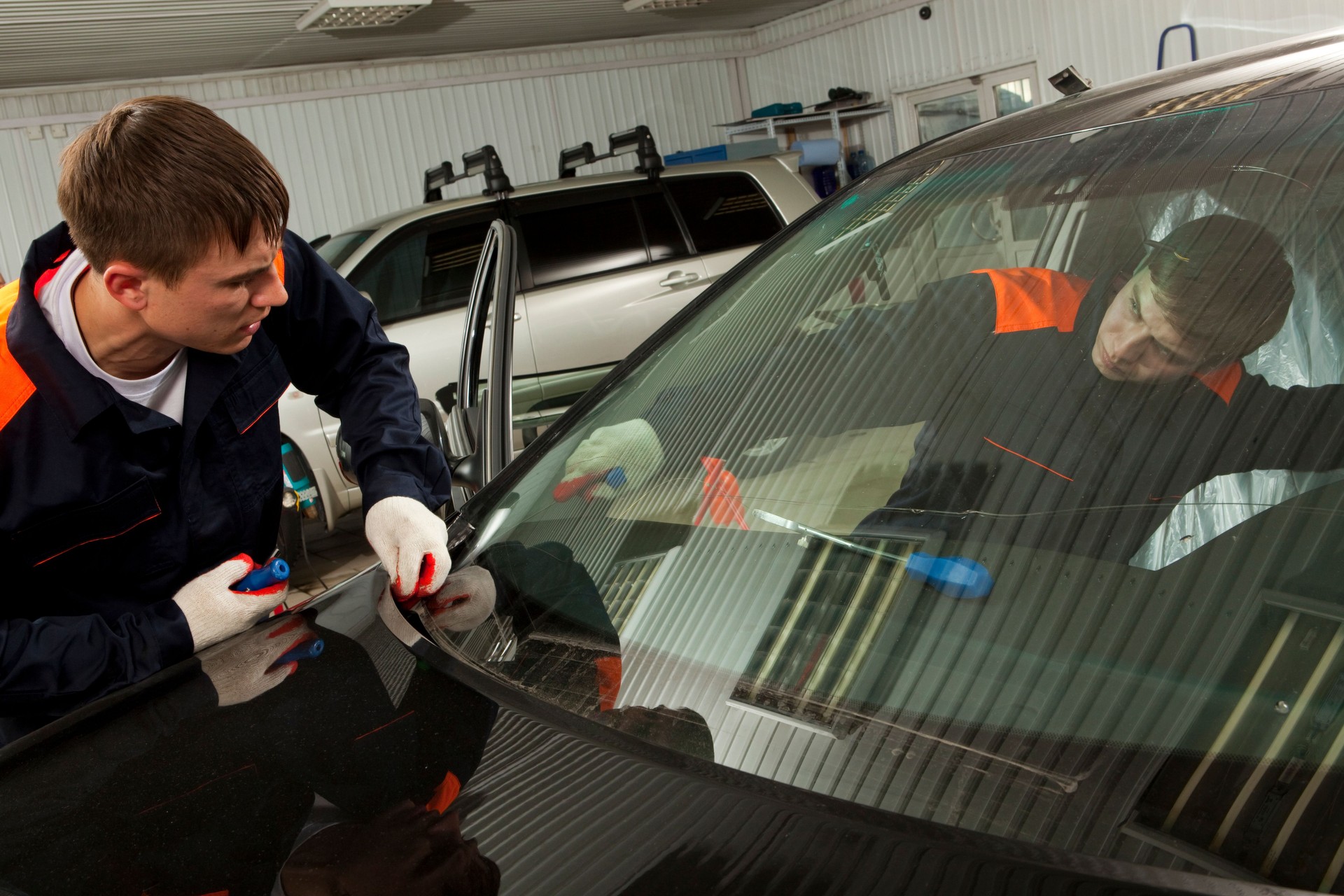 Two Real Mechanics working  in Auto Repair Shop.