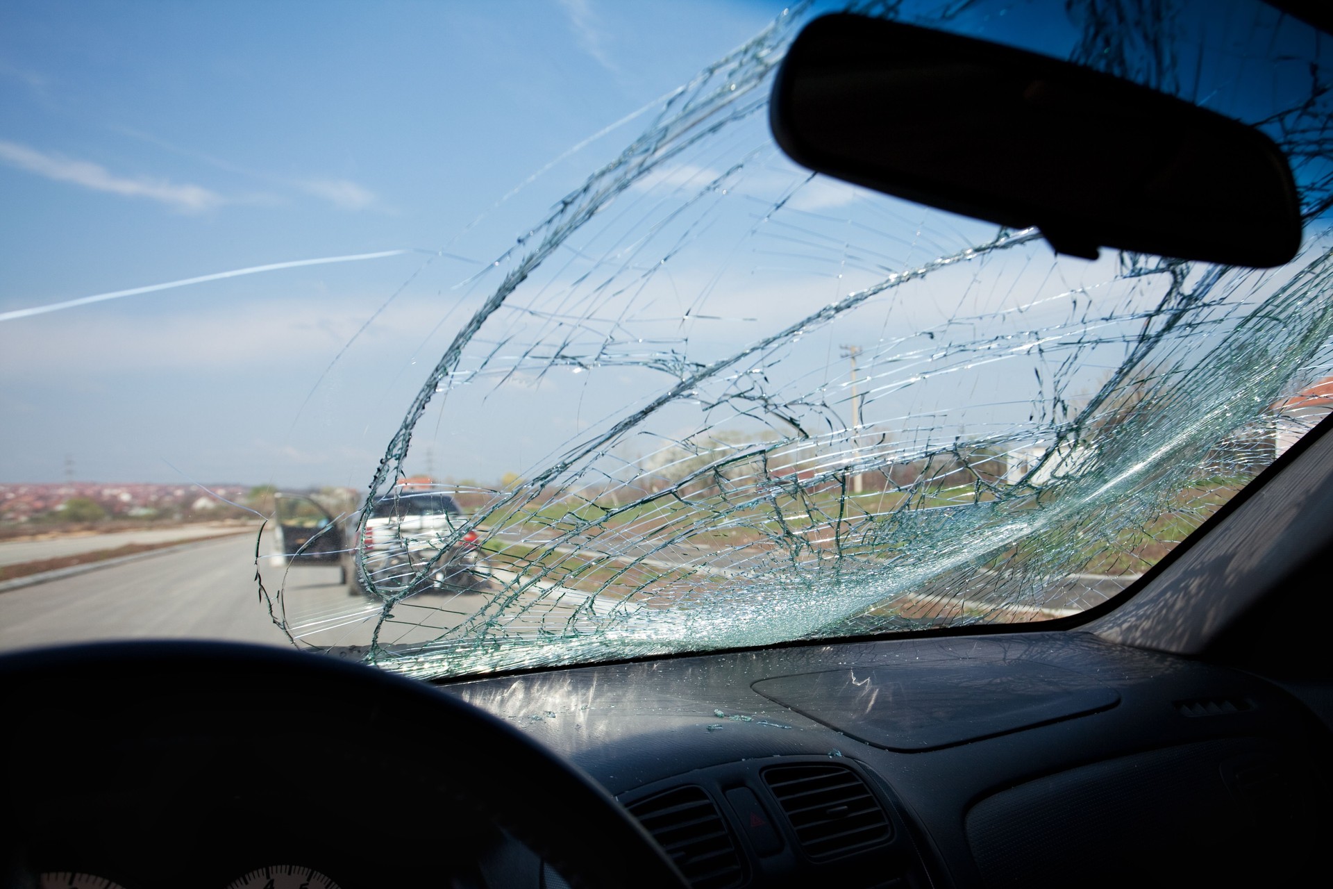 Inside of car with the broken windshield. Road accident